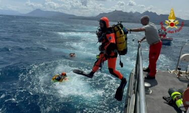 Divers search for the missing after the yacht sank on August 19.