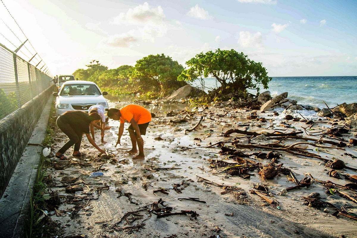 <i>Chewy Lin/AFP/Getty Images/File via CNN Newsource</i><br/>High-tide flooding and debris covers the road to the airport in the Marshall Islands capital Majuro on December 6