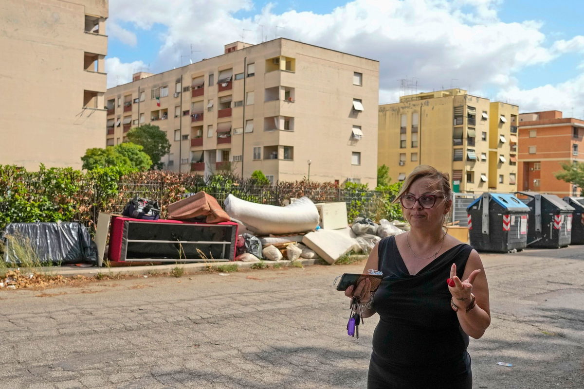 <i>Alessandra Tarantino/AP/FILE via CNN Newsource</i><br/>Anti-mafia activist Tiziana Ronzio walks through the Tor Bella Monaca neighborhood in Rome in 2021.