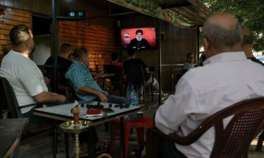 People watch a televised speech by Hezbollah leader Hassan Nasrallah at a coffee shop in a southern suburb of Beirut on August 25