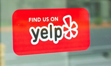 A red sticker decal promotes Yelp crowd-sourced reviews service - San Francisco