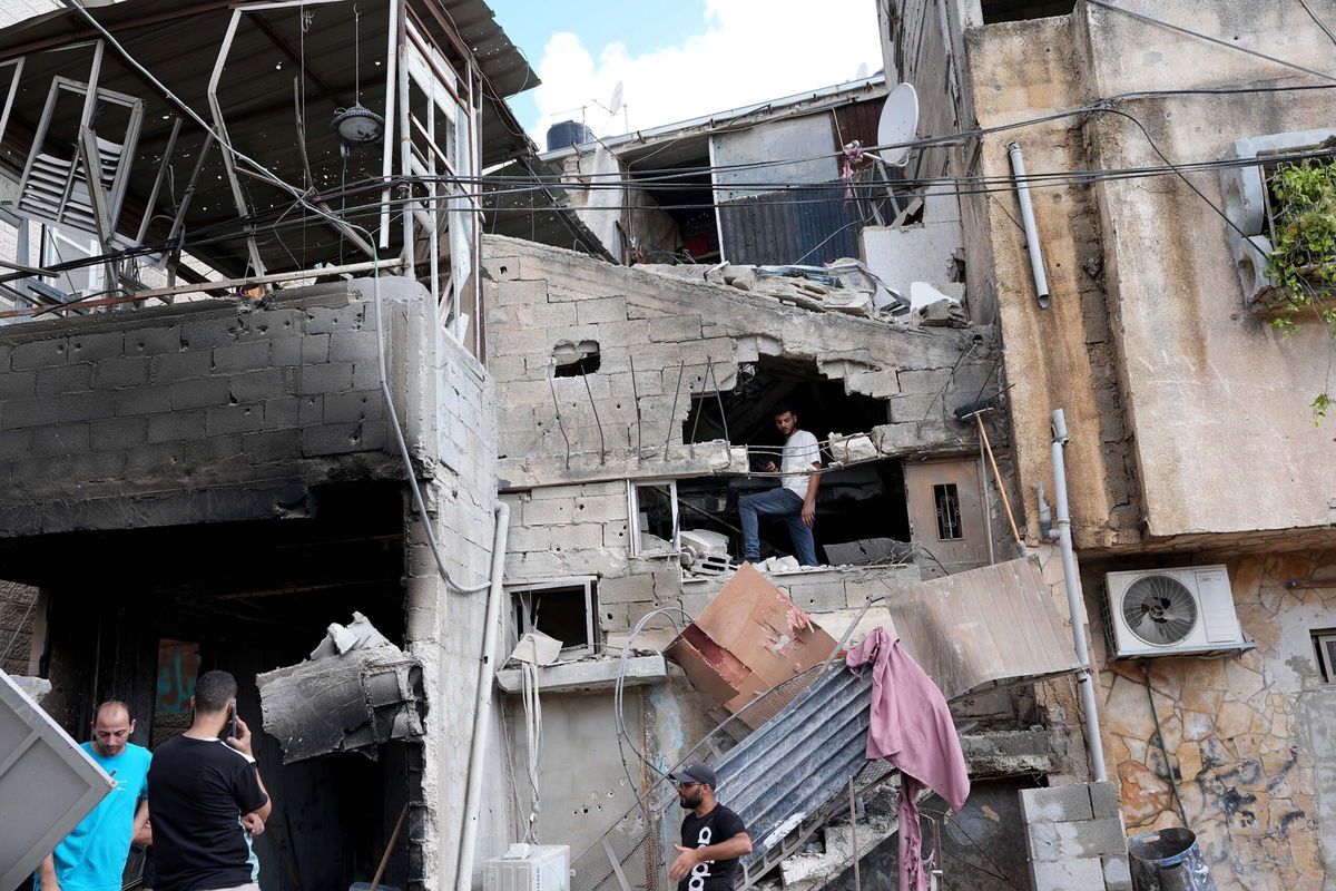 <i>Issam Rimawi/Anadolu/Getty Images via CNN Newsource</i><br/>Palestinians inspect the damage after Israeli soldiers raided the Nur Shams Refugee Camp in Tulkarem