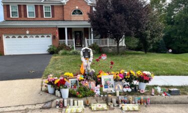 A makeshift memorial stands outside the Bhatt family home on August 29 after Naresh Bhatt is accused of killing his wife in their home then dragging her body outside