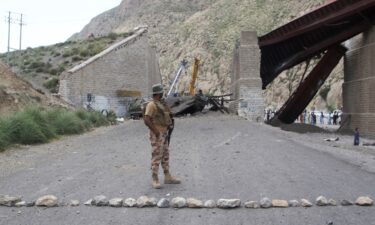 A paramilitary soldier stands on a road