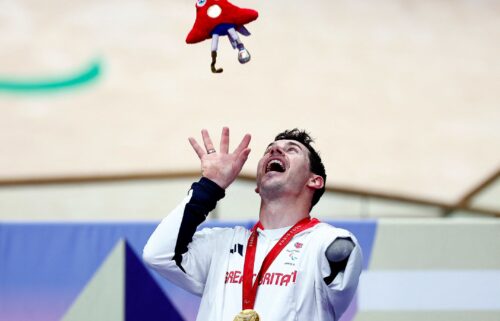 Jaco van Gass celebrates on the podium after taking the gold medal in the men's C3 3000m individual pursuit final.