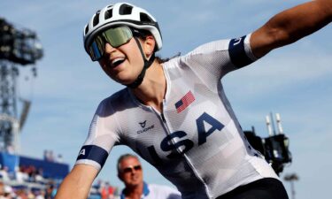 Kristen Faulkner of the United States celebrates at the finish line as gold medal winner during the women's road race on day nine of the Paris Olympics at the Trocadero on August 04