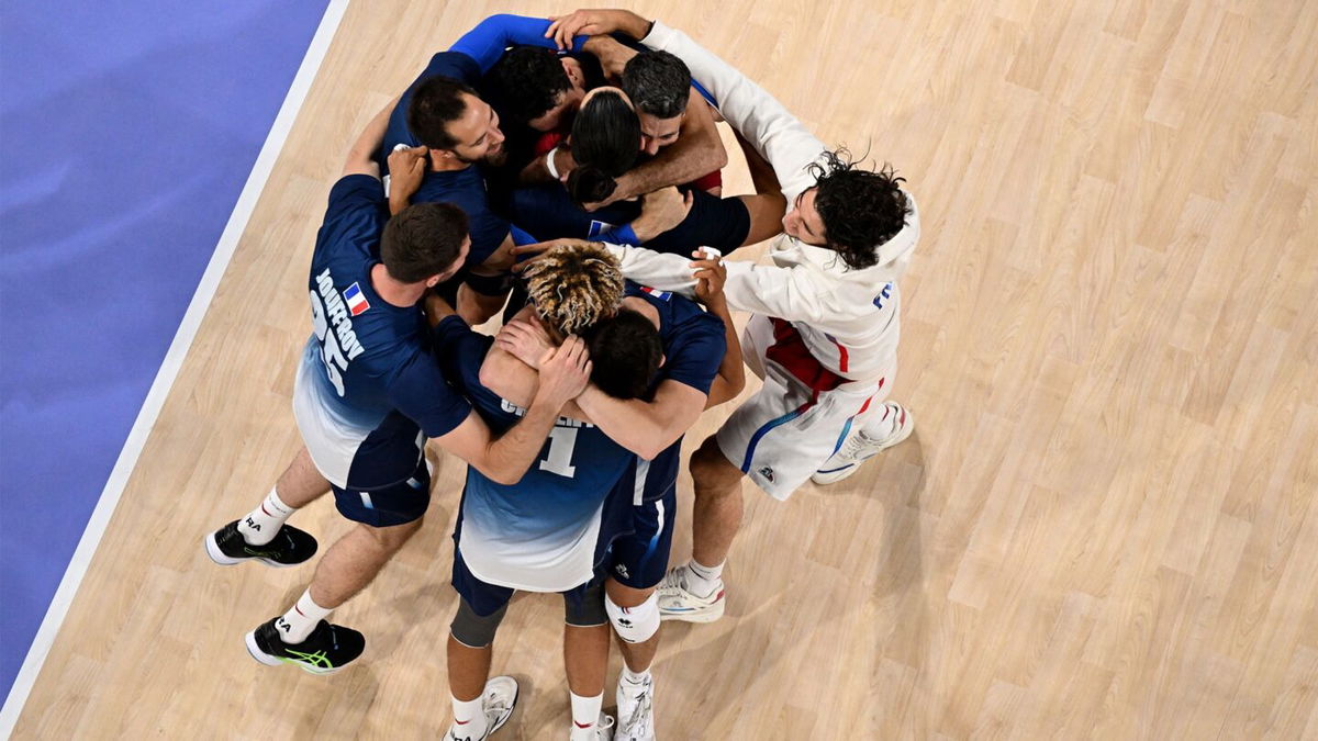 France's players celebrate after winning the men's volleyball semi-final match between Italy and France