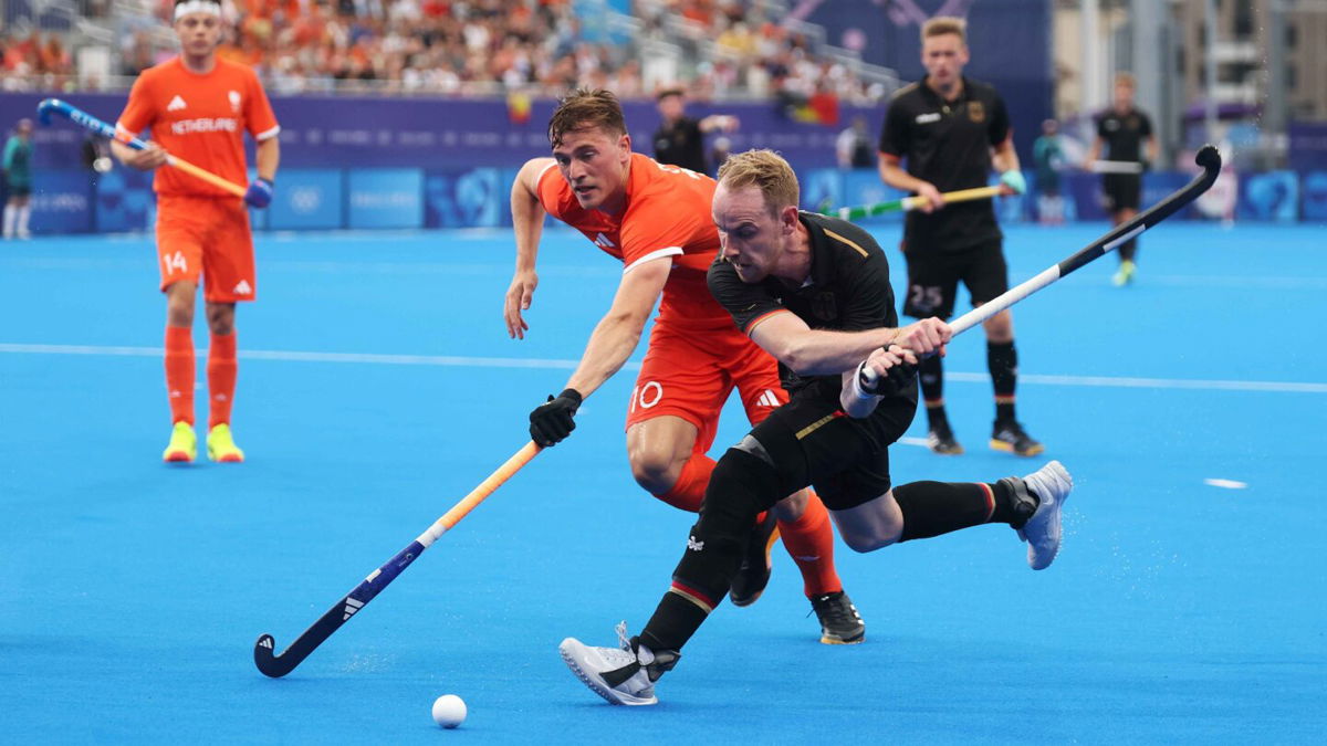 Christopher Ruehr of Team Germany shoots and misses whilst Jorrit Jan Willem Croon of Team Netherlands attempts to block during the Men's Pool A match between Germany and Netherlands on day five of the Olympic Games Paris 2024 at Stade Yves Du Manoir on July 31
