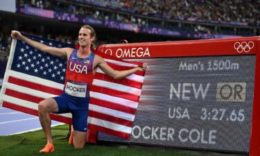 Cole Hocker of the United States poses with his new Olympic record after the men's 1500m final of track and field at the Paris Olympics on Aug. 6