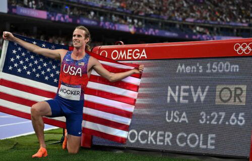 Cole Hocker of the United States poses with his new Olympic record after the men's 1500m final of track and field at the Paris Olympics on Aug. 6