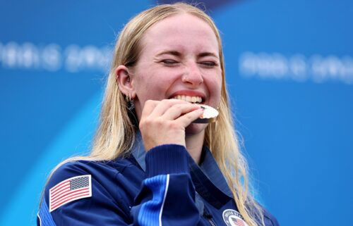 Bronze medalist Evy Leibfarth of Team United States bites her medal on the podium during the Women's Canoe Slalom Single medal ceremony