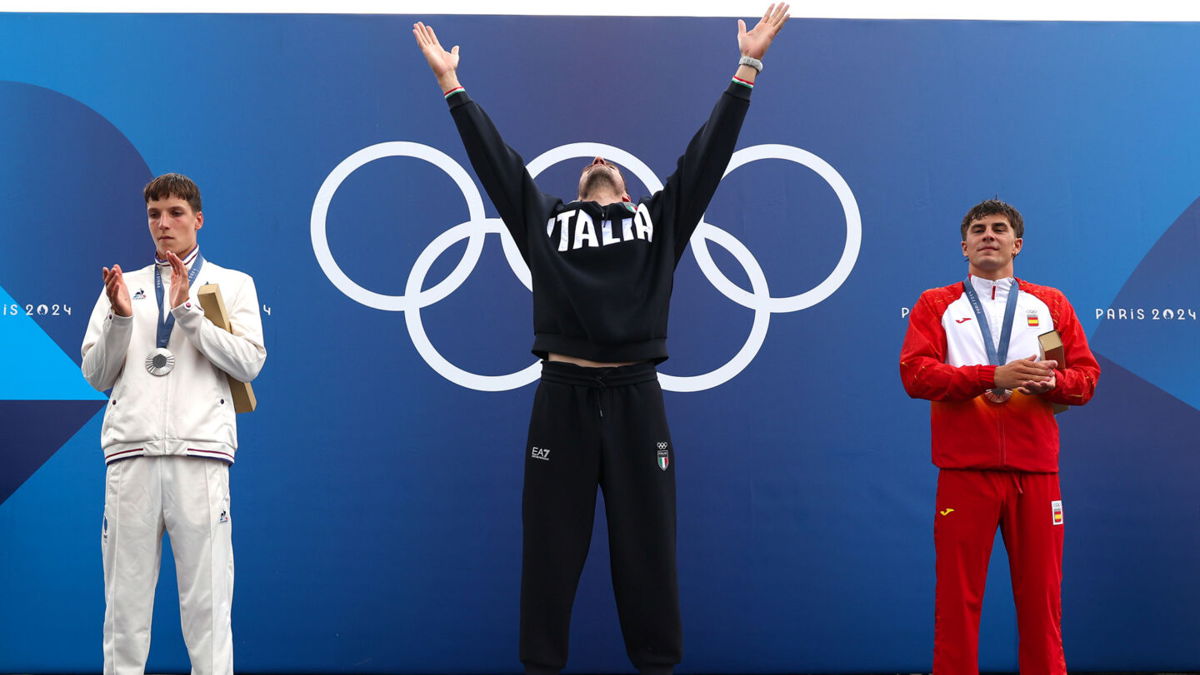 Gold medalist Giovanni de Gennaro of Team Italy celebrates on the podium during the Canoe Slalom Men's Kayak Single medal ceremony after the the Canoe Slalom Men's Kayak Single Final.