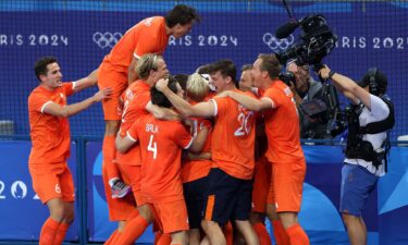 Team Netherlands celebrates after Duco Telgenkamp (obscured) scores the winning penalty in the shootout during the men's gold medal match between Germany and Netherlands on day 13 of the Paris Olympics at Stade Yves Du Manoir on August 08