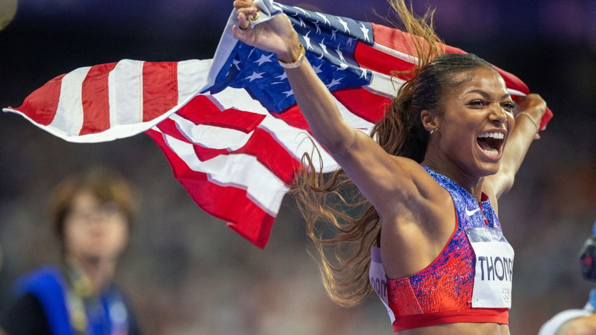 Gabby Thomas holds USA flag