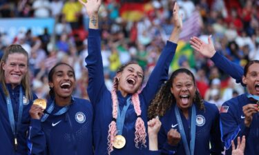 Members of the USWNT proudly show off their gold medals.