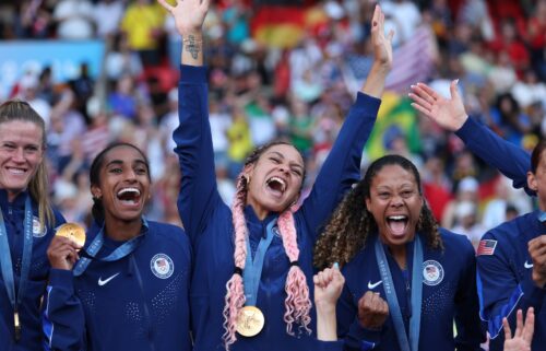 Members of the USWNT proudly show off their gold medals.