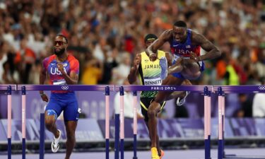 Grant Holloway jumps a hurdle