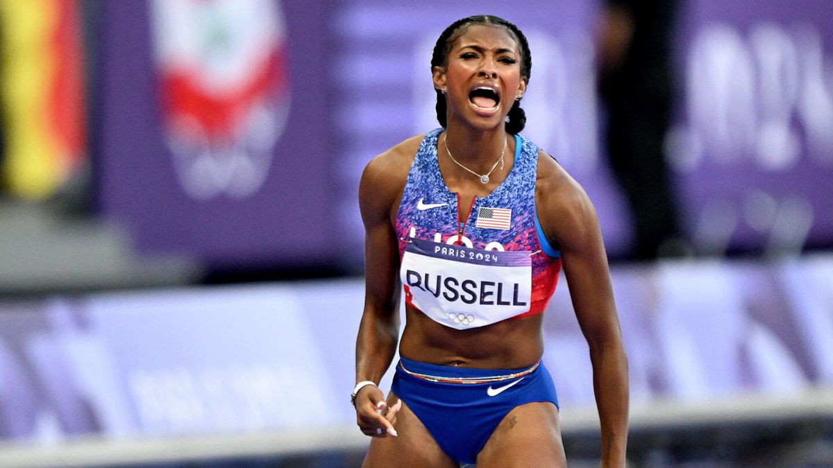 Masai Russell celebrates after 100m hurdles win