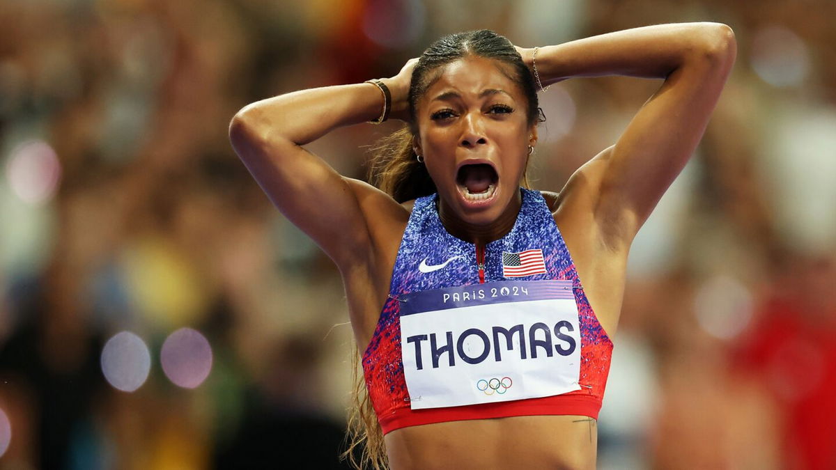 Gabby Thomas celebrates with hands on her head