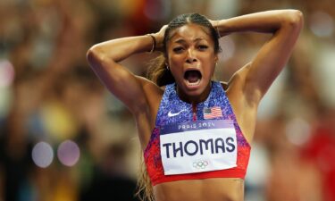 Gabby Thomas celebrates with hands on her head