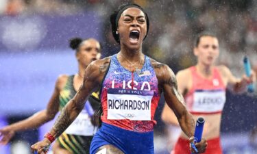 Sha'Carri Richardson crosses the finish line in the women's 4x100m