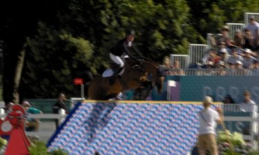 Rider on horseback jumps an obstacle