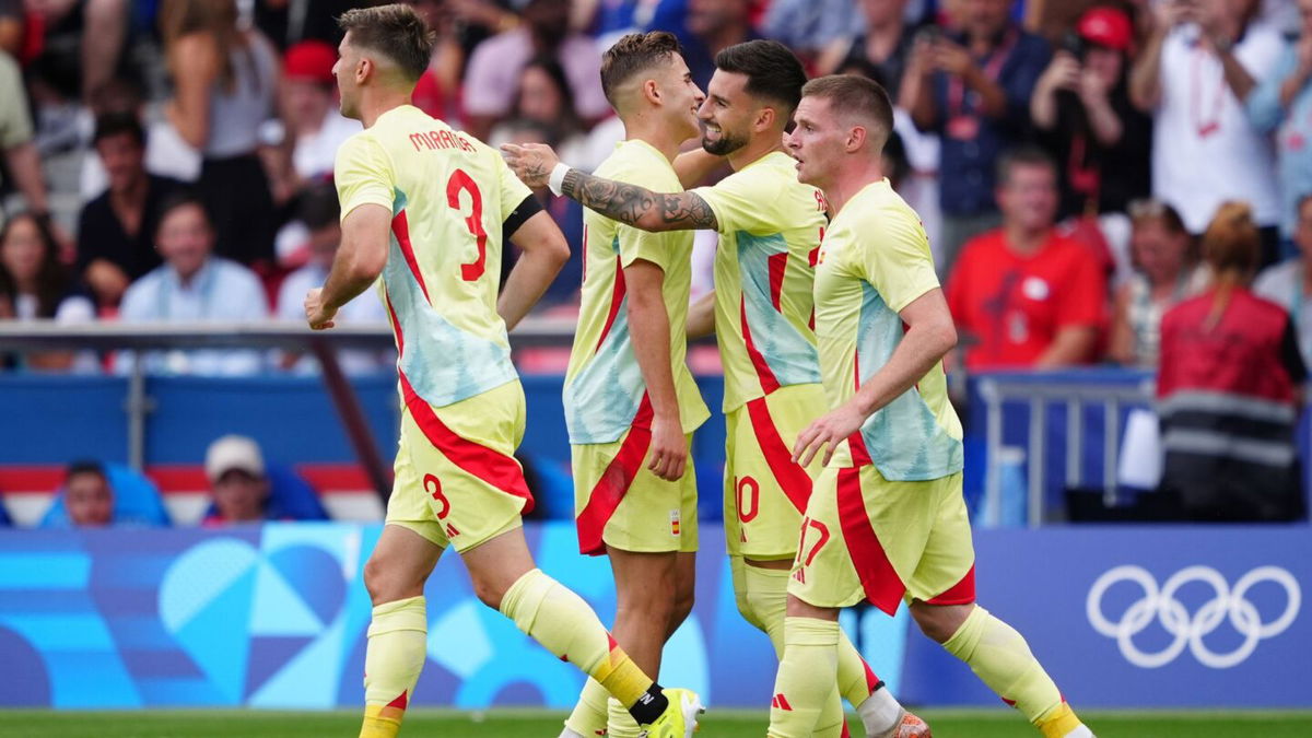 Spain players celebrate after scoring a goal