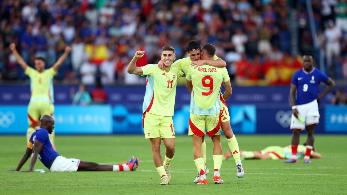 Spain players celebrate after winning a match.