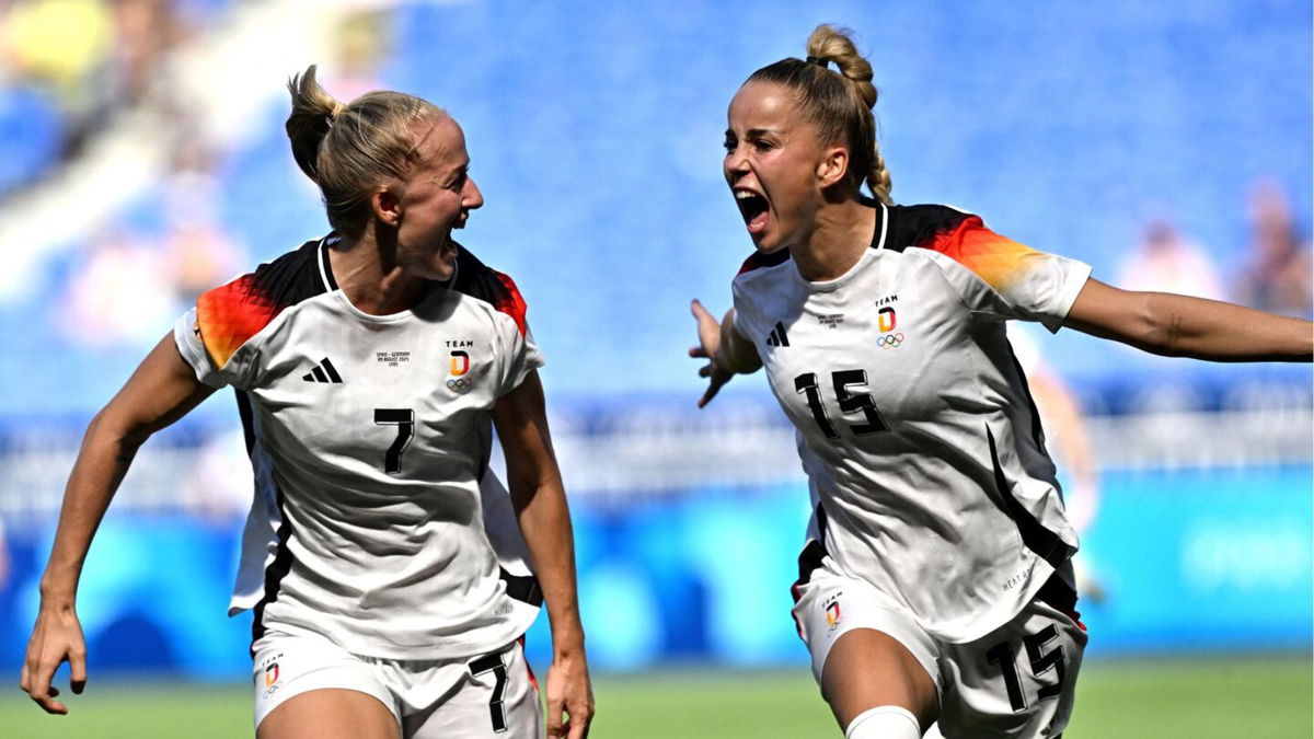 Germany players celebrate after scoring a goal.