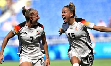 Germany players celebrate after scoring a goal.