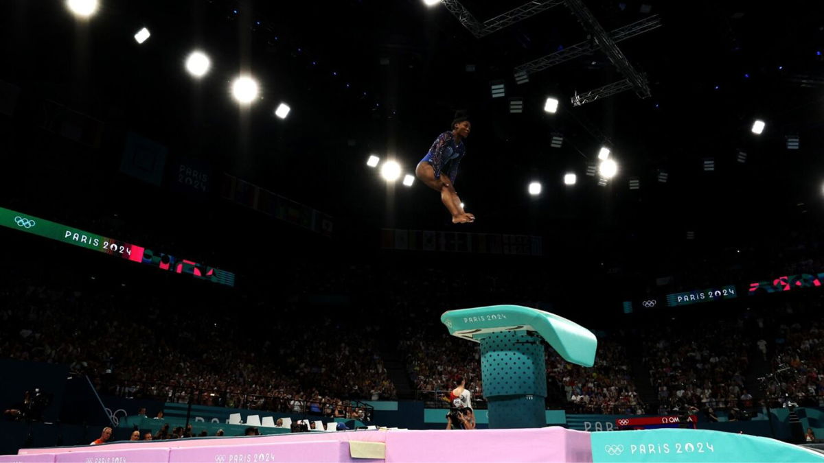 Simone Biles flips through the air