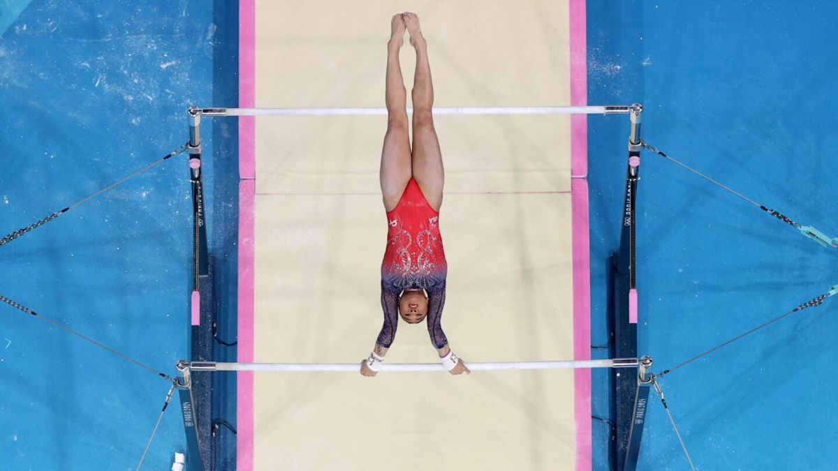 Suni Lee performs on bars