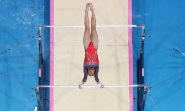 Suni Lee performs on bars