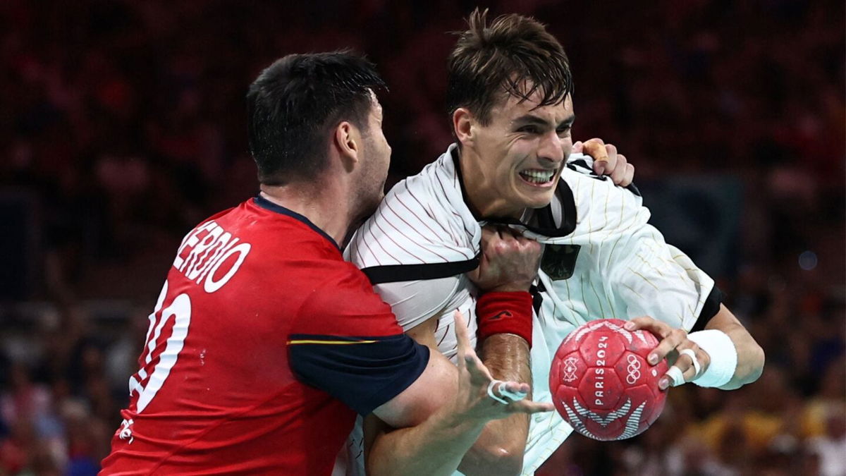 Two handball athletes contest for the ball.