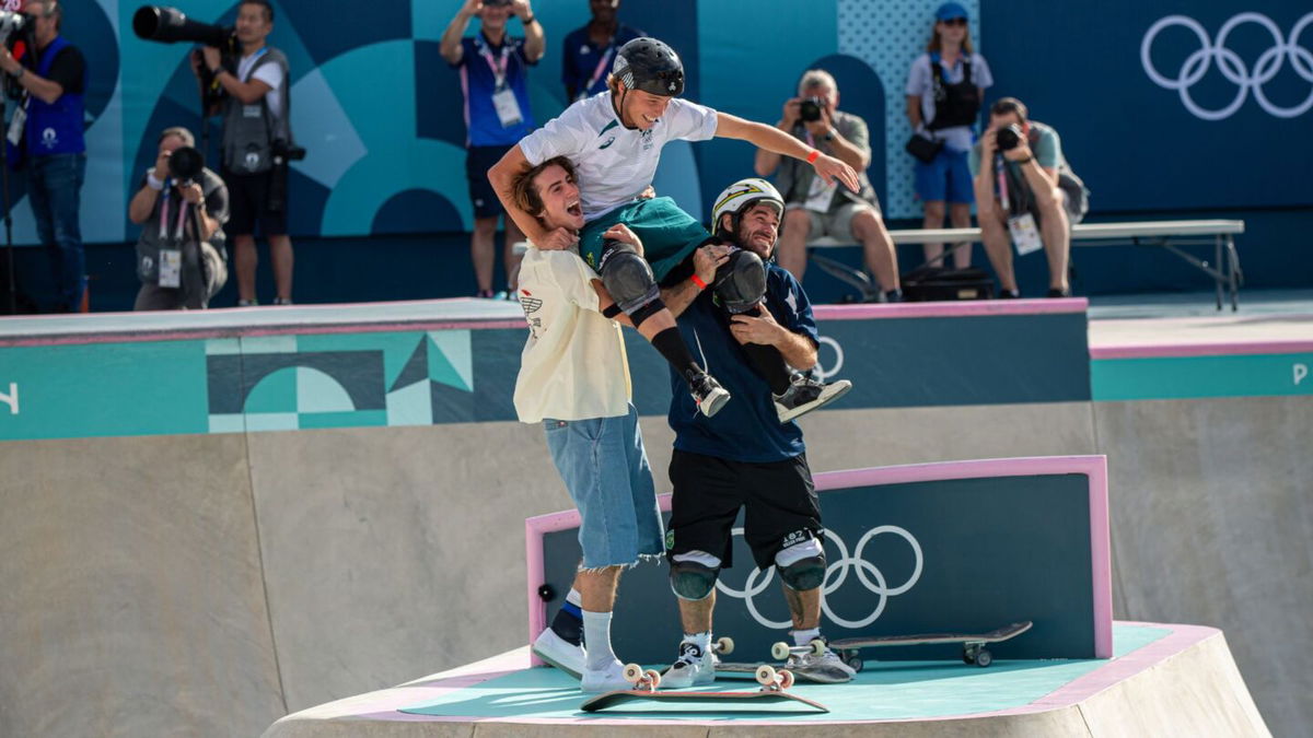 Tate Carew and Pedro Barros lift Keegan Palmer on their shoulders