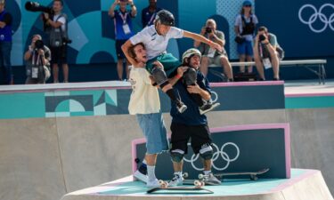 Tate Carew and Pedro Barros lift Keegan Palmer on their shoulders