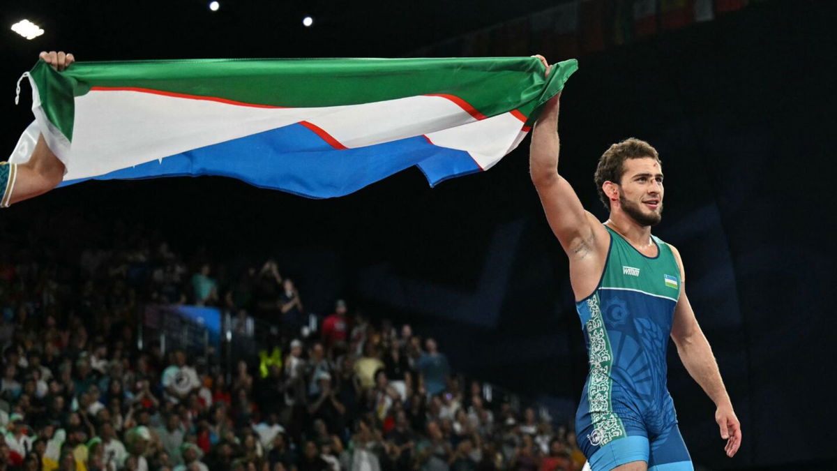 Razambek Jamalov holds Uzbek flag