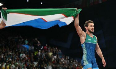 Razambek Jamalov holds Uzbek flag