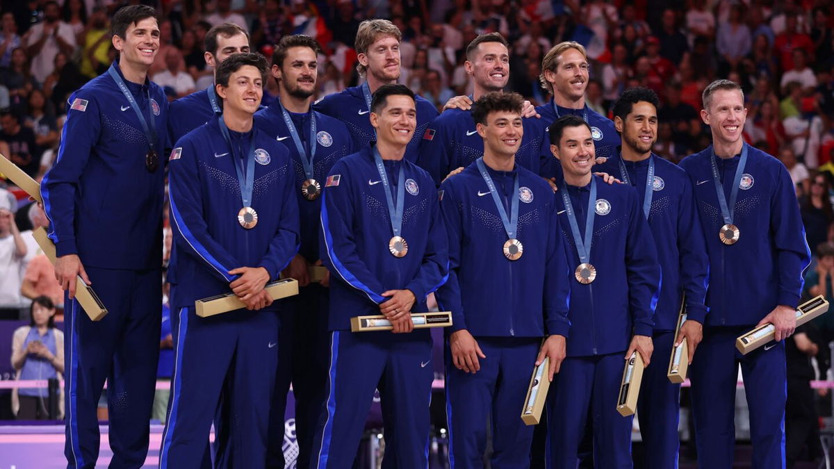 Bronze medalists of the United States celebrate on the podium during the Volleyball medal ceremony