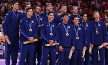 Bronze medalists of the United States celebrate on the podium during the Volleyball medal ceremony