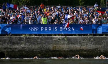 Spectators watch the women's 10km of marathon swimming in Paris