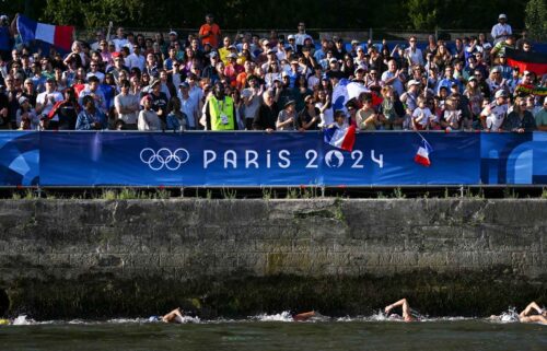 Spectators watch the women's 10km of marathon swimming in Paris