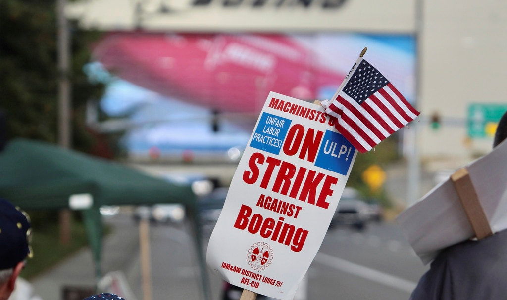 A strike sign is waved on the union machinist picket line near Boeing's factory in Everett, Washington, Thursday, Sept. 19.