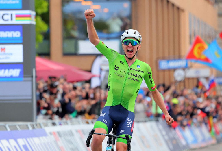 Tadej Pogačar celebrates winning the world championship men's road race.