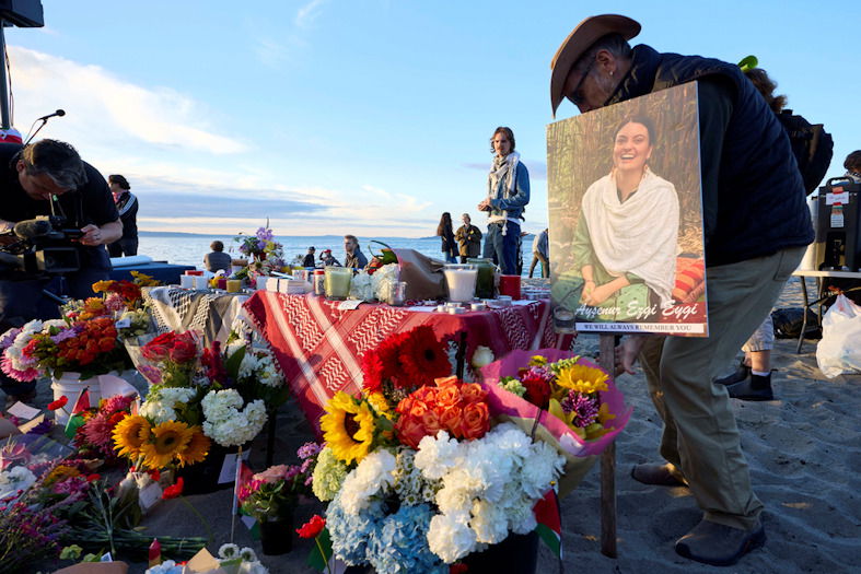 A photo is placed among flowers in memory of the death of the 26-year old Aysenur Ezgi Eygi at vigil on Alki Beach, killed recently in the occupied West Bank, Wednesday, Sept. 11, 2024, in Seattle. 