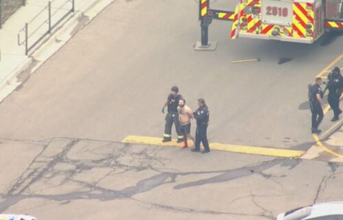 The gunman is led away from the King Soopers store by first responders.