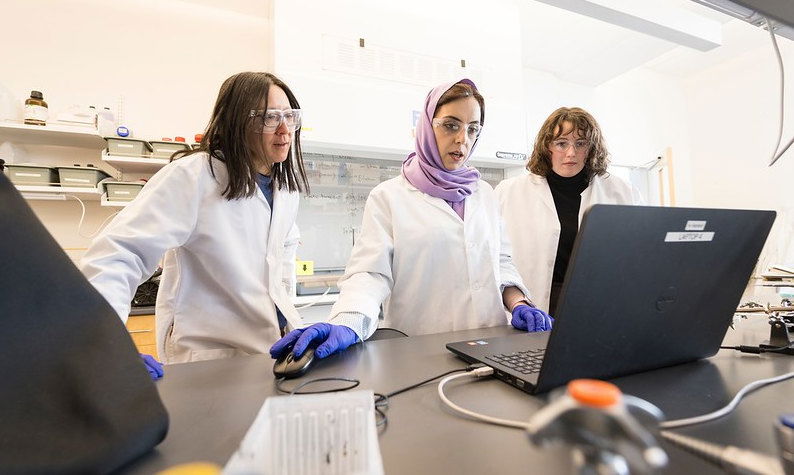 Doctoral students Khadijeh Khederlou, left, and Noel Lefevre, right, are working with College of Engineering faculty member Elain Fu on the development of a device to measure levels of anti-seizure medicine in the body via saliva. 