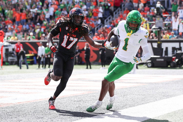 Oregon wide receiver Traeshon Holden (1) makes a catch for a touchdown as Oregon State defensive back Skyler Thomas (17) runs after him during the first half of Saturday's football game in Corvallis.