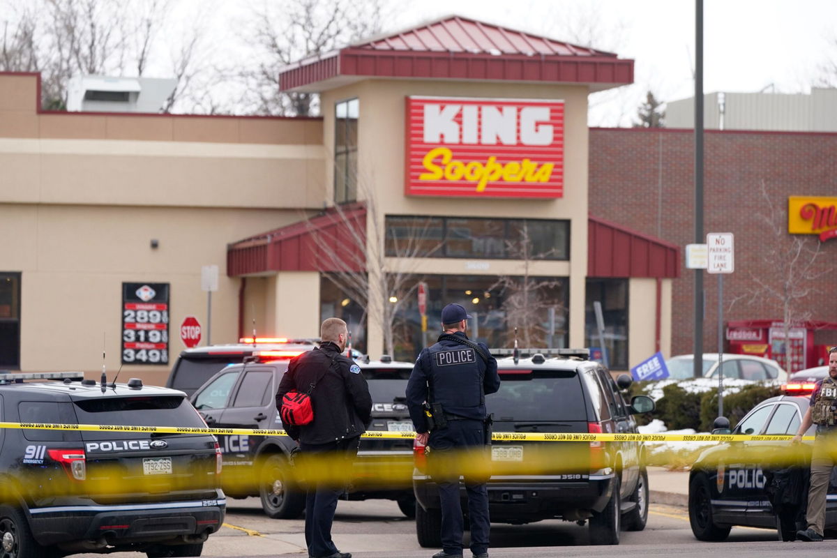 <i>David Zalubowski/AP via CNN Newsource</i><br/>Police stand outside a King Soopers grocery store in  Colorado after shooting on March 22