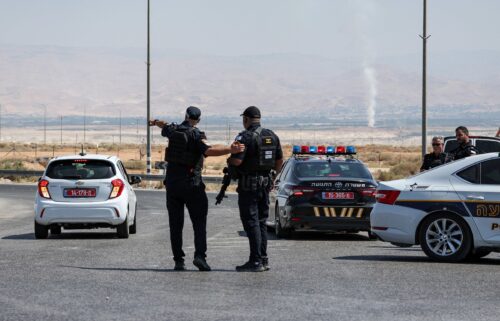 Israeli security forces gather at the scene of the attack near the Allenby Crossing on Sunday.